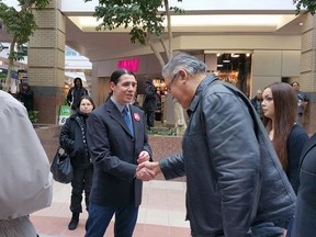 Winnipeg Centre MP Robert-Falcon Ouellette shakes hands with elder Joseph Meconse, Feb. 5, 2016.