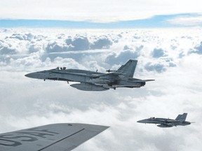 Royal Canadian Air Force CF-18 Hornets depart after refueling with a KC-135 Stratotanker assigned to the 340th Expeditionary Air Refueling Squadron, October 30, 2014, over Iraq. Canadian fighter jets taking part in the air campaign against the Islamic State of Iraq and the Levant have had a busy start to 2016. THE CANADIAN PRESS/HO-U.S. Air Force, Staff Sgt. Perry Aston