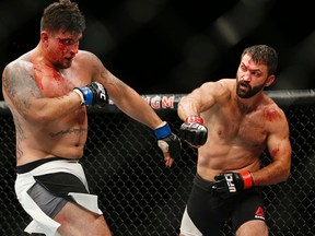 Andrei Arlovski, right, fights Frank Mir during their heavyweight bout at UFC 191 on Saturday, Sept. 5, 2015, in Las Vegas. (AP Photo/John Locher)