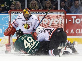 London Knights forward Max Jones and Owen Sound defenceman Damir Sharipzyanov collide with Attack goalie Michael McNiven during their OHL game at Budweiser Gardens on Friday night. (CRAIG GLOVER, The London Free Press)