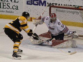 Kingston Frontenacs' Juho Lammikko tries a move on Oshawa Generals goalie Jeremy Brodeur during Ontario Hockey League action at the Rogers K-Rock Centre in Kingston on Friday. (Ian MacAlpine/The Whig-Standard)