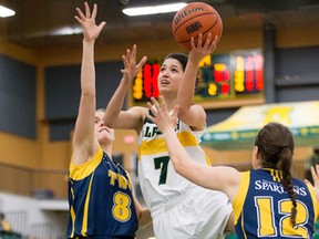 University of Alberta Pandas fourth-year guard Maddie Rogers drives the hoop against Trinity Western University Spartans Jamie Andrews Stobart (8) and Kristin Ford (12) on the way to an 83-63 win by the home side at the Saville Centre on Friday. (Greg Southam)