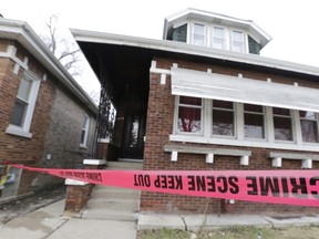 Crime scene tape surrounds a home Friday, Feb. 5, 2016, in Chicago. Chicago police are investigating what led to the deaths of two children, two women and two men whose bodies were found Thursday, with signs of trauma inside the home on the city's South Side. Chicago police Chief of Detective Eugene Roy said Friday morning that the victims appear to be from the same family. (AP Photo/M. Spencer Green)
