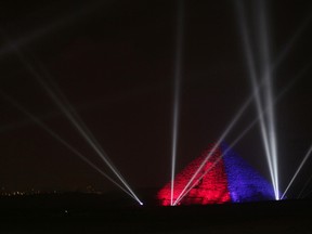 The Great Pyramids are illuminated for New Year's Eve in Giza, near Cairo, Egypt late Thursday, Dec. 31, 2015. (AP Photo/Maya Alleruzzo)