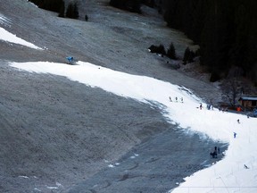 People ski on artificial snow from a snow cannon at a ski track in Tannheim, Austria, Wednesday, Dec. 30, 2015. (AP Photo/Matthias Schrader)