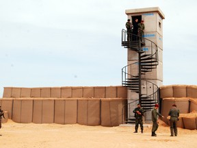Tunisian soldiers take part to a presentation of the anti-jihadi fence, in near Ben Guerdane, eastern Tunisia, close to the border with Libya, Saturday, Feb. 6, 2016.  (AP Photo/Benjamin Wiacek)