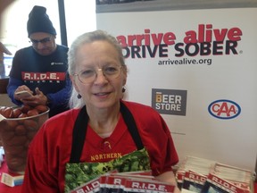 Anne Leonard, executive director of Arrive Alive DRIVE SOBER, works an education booth with tips on planning a safe Super Bowl Sunday at the Stockyards Beer Store on St. Clair Ave. W. (Kevin Connor, Toronto Sun)
