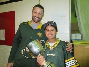 Edmonton Eskimos quarterback Mike Reilly and J.H. Picard student Nic Davis are all smiles as the Grey Cup visited the school recently. (SUPPLIED)