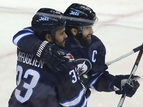 Jets defenceman Dustin Byfuglien (left) and captain Andrew Ladd are both scheduled to become unrestricted free agents on July 1. (Brian Donogh/Winnipeg Sun/Postmedia Network)
