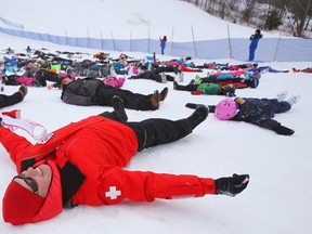 Ski patrol member Christian Balayer makes snow angels with 182 other patrollers and citizens Saturday at Batawa Ski Hill.