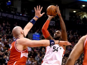 Toronto Raptors forward Patrick Patterson shoots the ball past the hand of Washington Wizards center Marcin Gortat. (Dan Hamilton/USA TODAY Sports)