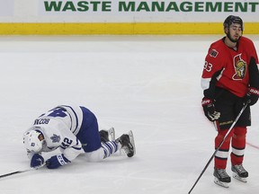 Senators forward Mika Zibanejad skates away after levelling Maple Leafs centre Tyler Bozak during the first period in Ottawa on Saturday night. Bozak left the game and did not return. (Tony Caldwell/Postmedia Network)
