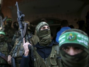 Palestinian Hamas militants take part in the funeral of their two comrades, who were killed when a tunnel collapse on Tuesday, in the village of Al-Moghraga near central Gaza Strip, February 3, 2016. Two militants of the Palestinian Islamist Hamas group died when a tunnel, they worked inside, collapsed on Tuesday, the group’s armed wing said. Leaders of Hamas said building tunnels was in preparation for any possible confrontation with Israel in the future. REUTERS/Mohammed Salem