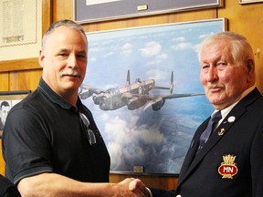 Mark Seibutus, left, of the Canadian Owners and Pilot Association, accepts recognition for his group's efforts from Doug Neely, an executive member of the Point Edward Ex-Servicemen's Club during the club's 90th anniversary celebration on Saturday.Photograph taken on Saturday, Feb. 6, 2016 at Sarnia, Ontario (Neil Bowen/Sarnia Observer)
