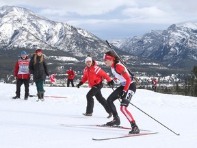 Julia Ranson of Kelowna, B.C., gets some encouragement from a coach as she competes in the women's sprint at the World Cup biathlon in Canmore on Friday. (Mike Ridewood/The Canadian Press)