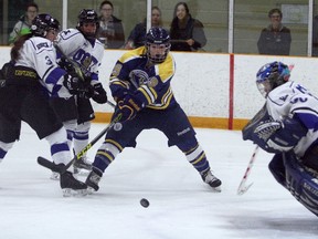 Laurentian Voyageurs forward Julie Hebert (19) takes a swat at a loose puck while UOIT Ridgebacks defenders Natasha Tymcio (3) and Gabriella Lamanna 26) look to hold her up and goaltender Tori Campbell (30) prepares tp make a save during OUA women's hockey action at Gerry McCrory Countryside Sports Complex in Sudbury on Sunday. Ben Leeson/The Sudbury Star/Postmedia Network