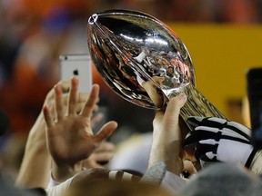 Members of the Denver Broncos hold the trophy after the NFL Super Bowl 50 football game against the Carolina Panthers, Sunday, Feb. 7, 2016, in Santa Clara, Calif. The Broncos won 24-10. (AP Photo/Matt Slocum)