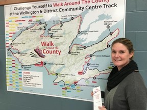 BRUCE BELL/The Intelligencer
Facilities manager Lisa Lindsay is pictured with a map of Prince Edward County at the Wellington and District Community Centre. Participants in the Walk Around the County program are currently using the track at Essroc Arena to walk their way around the shoreline of the municipality.