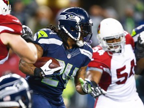 Seattle Seahawks running back Marshawn Lynch (24) rushes against the Arizona Cardinals during the second quarter at CenturyLink Field.  Joe Nicholson-USA TODAY Sports