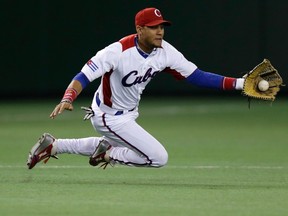 Cuban third baseman Yulieski Gurriel catches the ball during a game against Taiwan at the World Baseball Classic (WBC) in Tokyo March 9, 2013. (REUTERS/Toru Hanai)