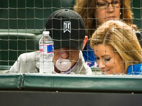 In this April 14, 2005 file photo, Johnny Manziel blows a bubble as he watches from the seats behind home plate with Colleen Crowley as the Texas Rangers face the Los Angeles Angels in a baseball game at Globe Life Park in Arlington, Texas. (Smiley N. Pool/The Dallas Morning News)