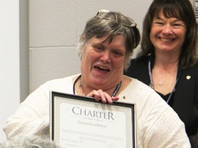 Christine Huctwith holds the charter certificate for Sarnia-Lambton's new Aktion Club. Huctwith, club president, was one of the people at Wawanosh Enterprises Monday celebrating the official start of the service club chapter for adults with disabilities. Tyler Kula/Sarnia Observer/Postmedia Network