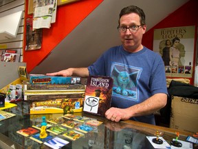 Gord Mood of L.A. Mood shows off just a few of their family board games that will be on display for families to try out on Family Day at Centennial Hall. (MIKE HENSEN, The London Free Press)