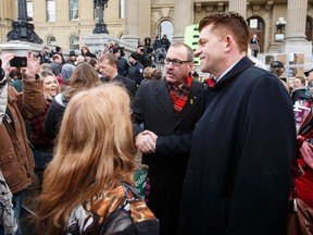 PC leader Ric McIver (left) shakes hands with Wildrose Party leader Brian Jean during an anti-Bill 6 rally put on by the Wildrose Party in front of the Alberta Legislature in Edmonton Dec. 3. (EDMONTON SUN/File)