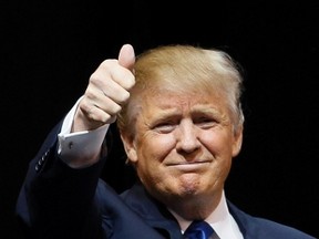 Republican U.S. presidential candidate Donald Trump gives a thumbs up as he enters the Verizon Wireless Arena for a campaign event in Manchester, New Hampshire, February 8, 2016. REUTERS/Rick Wilking