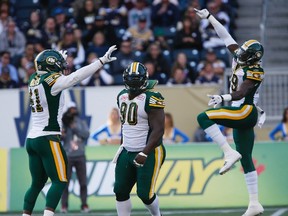 Odell Willis and Almondo Sewell celebrate a sack against the Winnipeg Blue Bombers last October. (Canadian Press photo)