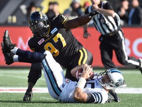 Argonauts quarterback Ricky Ray (15) is sacked by Tiger-Cats' Ted Laurent during the CFL's Eastern Division Semifinal in Hamilton, Ont., on Sunday, Nov. 15, 2015. (Frank Gunn/The Canadian Press)