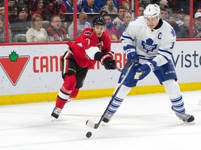 Toronto Maple Leafs defenseman Dion Phaneuf (3) skates with the puck in front of Ottawa Senators center Kyle Turris (7) in the second period at the Canadian Tire Centre. Marc DesRosiers-USA TODAY Sports