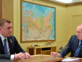 In this photo taken Feb. 2, 2016, Russian President Vladimir Putin, right, meets with Alexei Dyumin whom he named the acting governor of the Tula region, southwest of Moscow, in the Novo-Ogaryovo residence outside Moscow, Russia. (Alexei Druzhinin/Sputnik, Kremlin Pool Photo via AP)