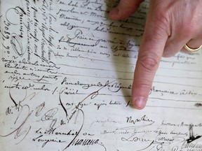 David Lowenherz  points to the signatures of Napoleon Bonaparte and to the left, Josephine de Beauharnais, on a marriage contract, in West Palm Beach, Fla. (AP Photo/Lynne Sladky)