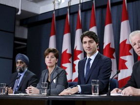 Canada's Prime Minister Justin Trudeau (2nd R) takes part in a news conference with Defence Minister Harjit Sajjan  (L), International Development Minister Marie-Claude Bibeau (2nd L) and Foreign Minister Stephane Dion in Ottawa, Canada, February 8, 2016. REUTERS/Chris Wattie