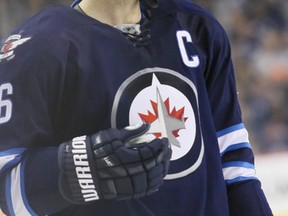 Winnipeg Jets left wing Andrew Ladd (16) gets set for a face-off in the Jets zone during the third period against the Carolina Hurricanes at MTS Centre.