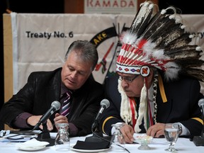 Onion Lake First Nation Chief Wallace Fox confers with legal counsel Robert Hladun during a press conference at the Ramada Inn in Edmonton on Wednesday Nov 26, 2014. Photo: John Lucas/Postmedia Network