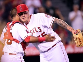 Mat Latos (right) of the Los Angeles Angels celebrates a win over the Oakland Athletics with Carlos Perez at Angel Stadium of Anaheim on September 29, 2015 in Anaheim, Calif. (Harry How/Getty Images/AFP)