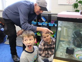 Lansdowne Public student Alastair Park hams it up for his classmates Tuesday as he and fellow student Kennedy Keating show off the classroom salmon aquarium to Bluewater Anglers president Dick Bornais. Chinook salmon are being raised by staff and students at three Sarnia schools through a pilot education initiative organized by the Bluewater Anglers and its hatchery. Barbara Simpson/Sarnia Observer/Postmedia Network