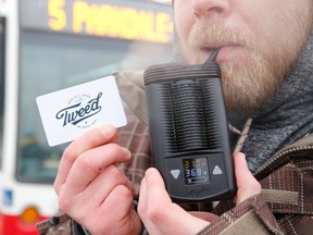 Jason Miller/The Intelligencer
Christopher Hobin, pictured here in front the number five bus, shows his medical marijuana card and vaporizing device at the transit terminal. Hobin was told to leave a city bus in December after he used the device while on the bus.