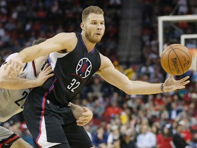 Los Angeles Clippers’ Blake Griffin is defended by Houston Rockets’ Donatas Motiejunas in Houston, in this file photo taken December 19, 2015. (Thomas B. Shea/USA TODAY Sports/Files)