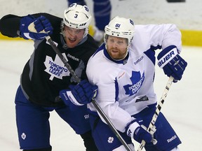Dion Phaneuf battles with Phil Kessel during Leafs practice at the Mastercard Centre in Toronto on Tuesday November 26, 2013. Dave Abel/Toronto Sun/QMI Agency