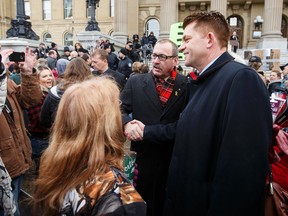 PC leader Ric McIver (centre left) shakes hands with Wildrose Party leader Brian Jean (right) during an anti-Bill 6 rally put on by the Wildrose Party in front of the Alberta Legislature in Edmonton, Alta., on Thursday, December 3, 2015. Ian Kucerak/Postmedia Network