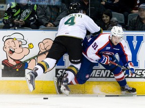 Windsor Spitfires forward Aaron Luchuk dodges a hit by Knights defenceman Olli Juolevi during an OHL game in London on Dec.4.
(Craig Glover/Postmedia Network)