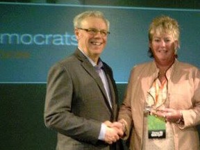 Heather Grant-Jury is pictured here receiving the Stanley Knowles Solidarity Award at the 2013 Manitoba NDP convention in Brandon, with then-premier Greg Selinger. Grant-Jury, a former high-ranking operative of Selinger, has been charged with fraud.
