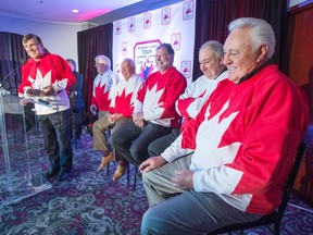 Team Canada 1972 player Serge Savard speaks to reporters as former teammates Pat Stapleton, left to right, Yvan Cournoyer, Peter Mahovolich, Guy Lapointe and Phil Esposito look on at a news conference in Montreal on Tuesday, Feb. 9, 2016. (THE CANADIAN PRESS/Ryan Remiorz)