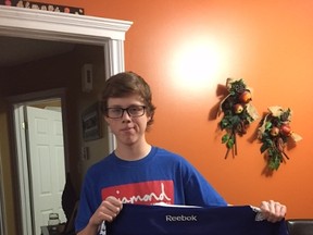 Tanner Fitzpatrick holds his Toronto Maple Leafs jersey signed by Dion Phaneuf. (Supplied)