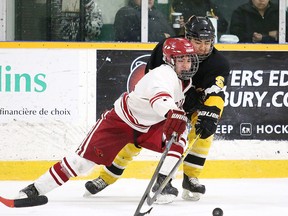 Alex Paul of the St. Charles Cardinals battles for the puck with Dylan Francis of the Manitoulin Mustangs during division 1 high school semi-final action from the Carmichael Arena in Sudbury, Ont. on Monday February 8, 2016. Gino Donato/Sudbury Star/Postmedia Network