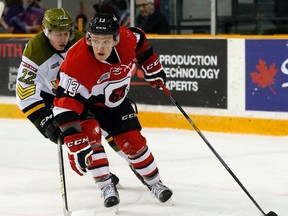 Artur Tyanulin of the Ottawa 67's is chased by North Bay Battalion's Brady Lyle on Feb. 9. (Darren Brown, Postmedia Network)
