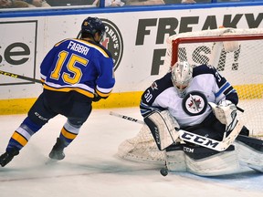 Feb 9, 2016; St. Louis, MO, USA; Winnipeg Jets goalie Connor Hellebuyck (30) blocks the shot of St. Louis Blues center Robby Fabbri (15) during the third period at Scottrade Center. The Winnipeg Jets defeat the St. Louis Blues 2-1 in a shootout. Mandatory Credit: Jasen Vinlove-USA TODAY Sports